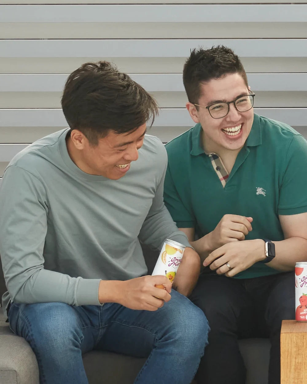 Yoju founders Steven and Kenn laughing together on a couch